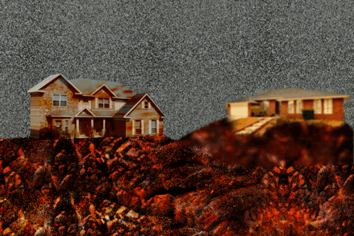 a house sits on top of a hill with a pile of dirt in front of it