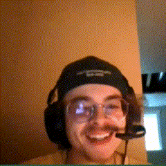 a man wearing headphones and a hat with a skull and crossbones on it