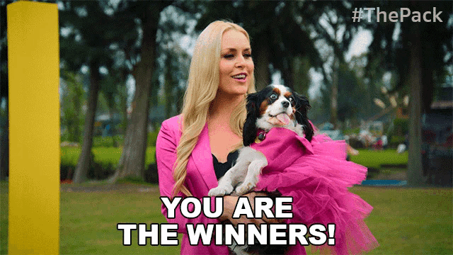 a woman holding a dog with the words you are the winners on the screen