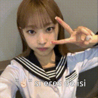 a girl in a school uniform is making a peace sign with her fingers