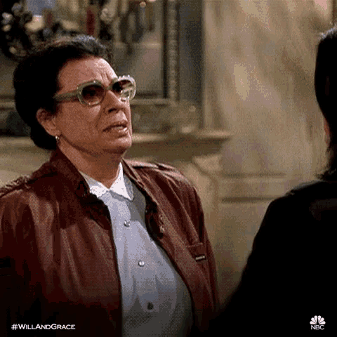 an older woman wearing sunglasses and a leather jacket is talking to a younger woman .