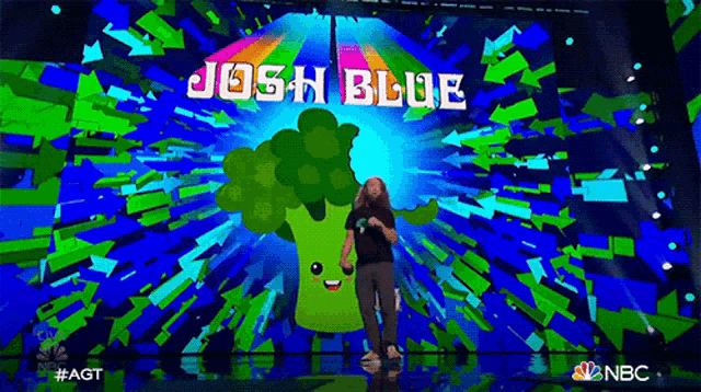 a man is standing in front of a screen that says josh blue on it