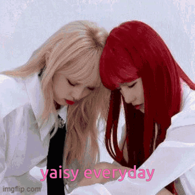 two women with red hair are hugging each other and the words yaisy everyday are on the bottom .