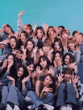 a group of young women posing for a picture with their hands up