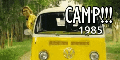 a woman is leaning out of the window of a yellow van with the words `` camp 1985 '' written on it .