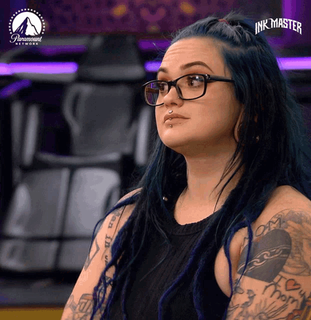 a woman with blue hair and glasses appears on a paramount network show called ink master