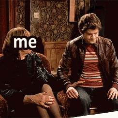 a man and a woman are sitting on a couch and the woman has the word me written on her face