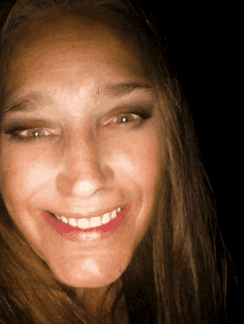 a close up of a woman 's face with her mouth open