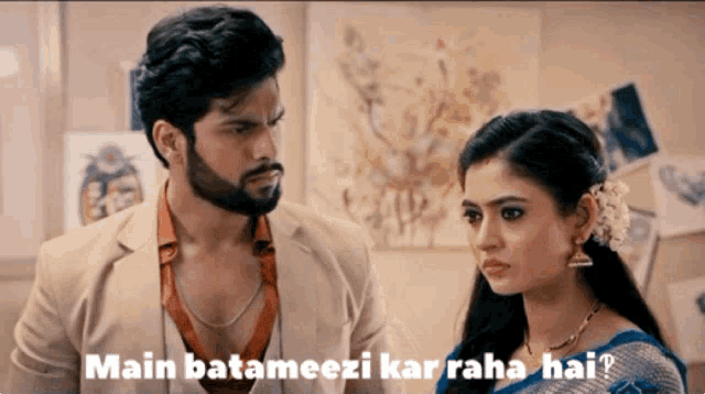 a man and a woman are standing next to each other and the man says " main batameezi kar raha hai "