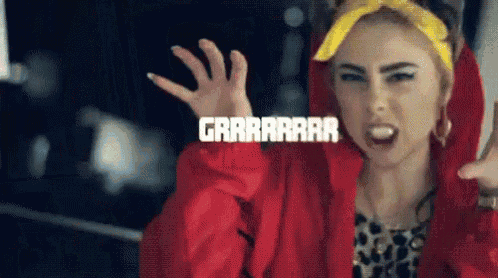 a woman wearing a red jacket and a yellow headband is making a funny face while screaming .