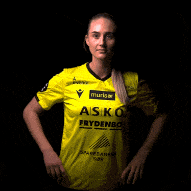 a woman is wearing a yellow shirt that says asko frydenbo