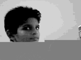 a black and white photo of a young boy looking at the camera