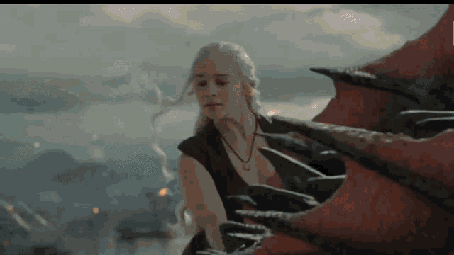 a woman is standing next to a dragon with a necklace around her neck