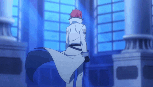 a man with red hair is standing in front of a blue window