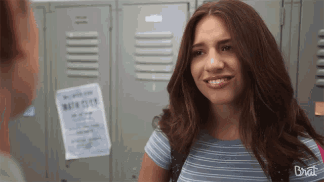 a girl standing in front of lockers with a poster on the wall that says " math club "