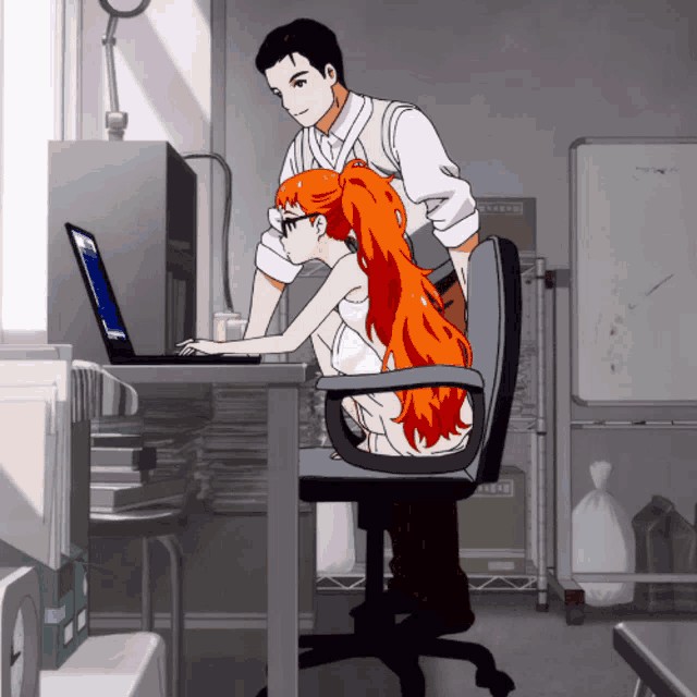 a man and a girl are looking at a laptop in an office