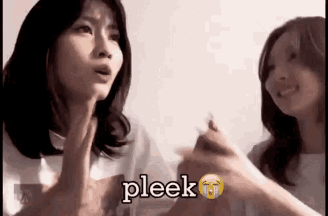 two women are sitting next to each other and one of them is crying while the other is smiling .