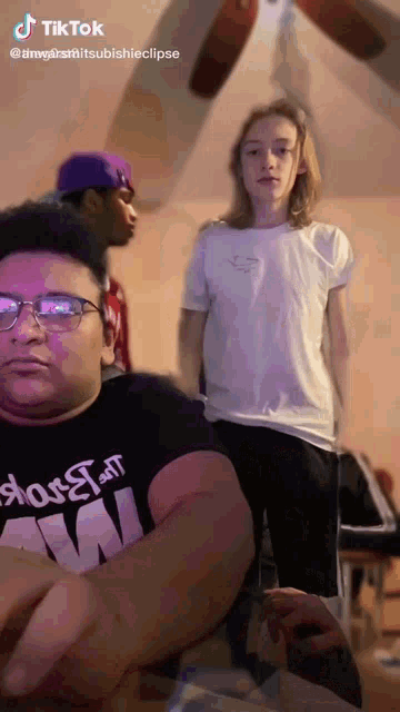 a man wearing glasses and a shirt that says ' aw '
