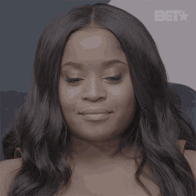 a close up of a woman 's face with a bet logo in the corner