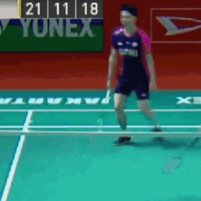 a person playing badminton with a scoreboard that says yunex on it