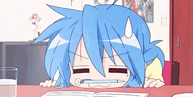 a girl with blue hair is sitting at a table with a pencil in her mouth .
