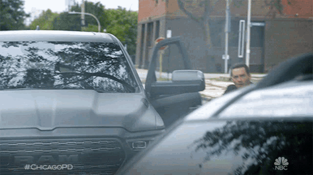 a ram truck is parked on the side of the road next to another vehicle