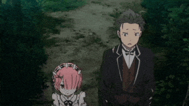 a man in a suit and bow tie stands next to a girl in a maid outfit