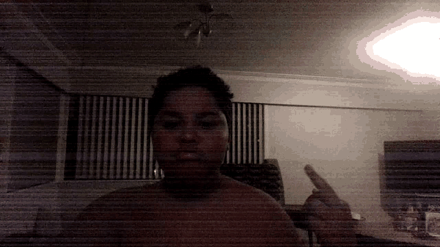 a blurry picture of a person giving the middle finger