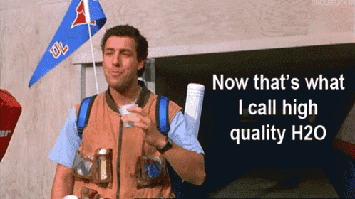 a man holding a cup with the words now that 's what i call high quality h20