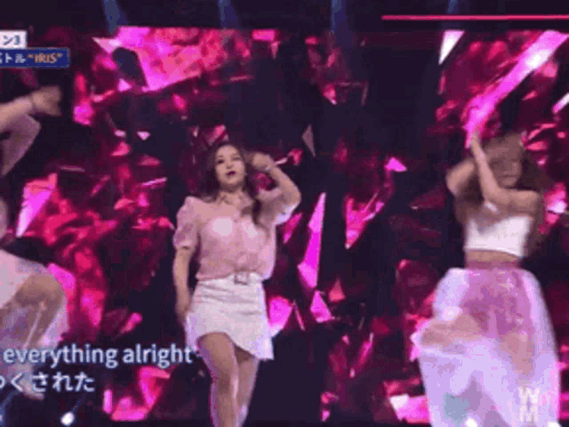 a woman in a pink shirt is dancing on a stage with the words everything alright in the corner