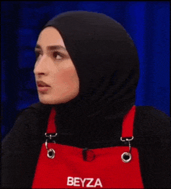 a woman wearing a hijab and an apron that says beyza on it