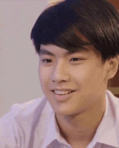 a close up of a young man 's face smiling .