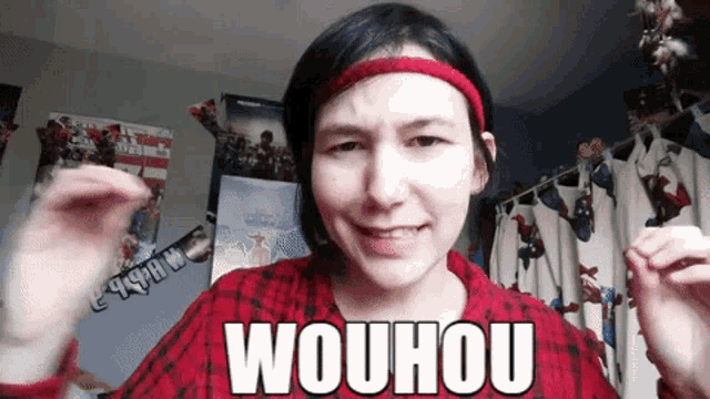 a woman wearing a red plaid shirt and a headband says wouhou