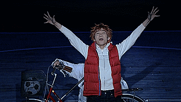 a man in a red vest is making a funny face with his mouth open