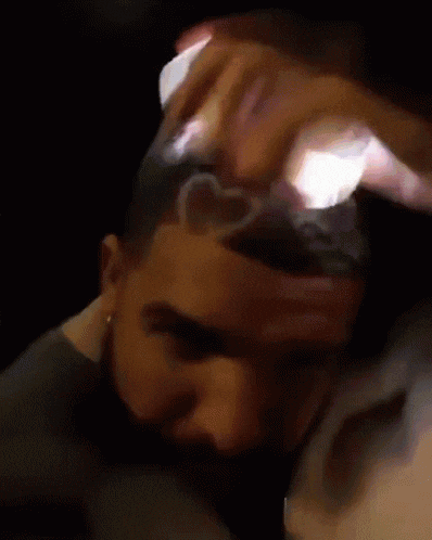 a close up of a person 's face with a light shining on it .