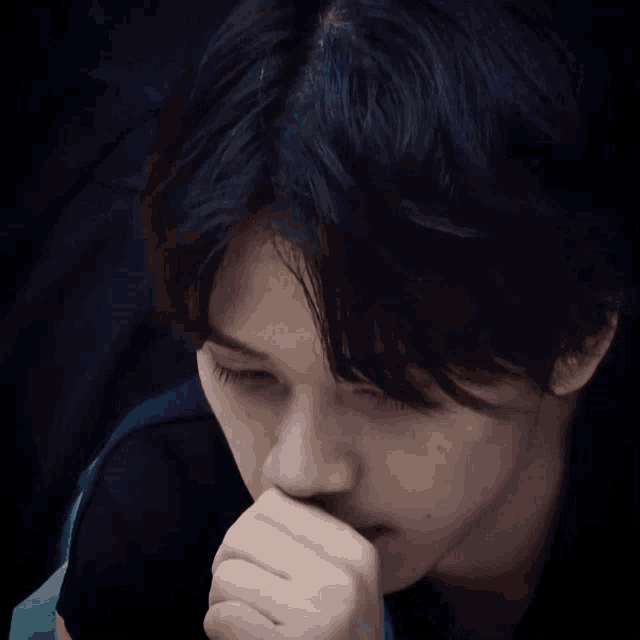 a close up of a person with their hand on their face