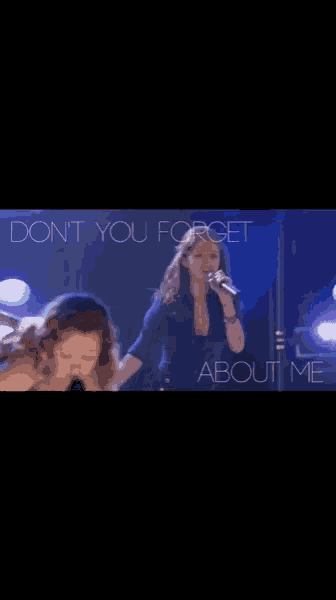 a woman singing into a microphone with the words do n't you forget about me