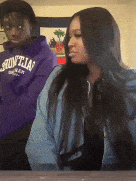 a man in a purple hoodie that says ' frontal ' on it