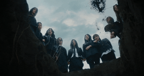 a group of girls are standing in a circle holding hands