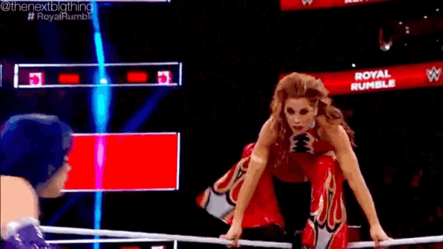 a woman in a wrestling ring with the words royal rumble on the screen