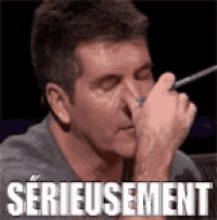 a man is covering his nose with his hand and the word serieuement is on the bottom of the picture .
