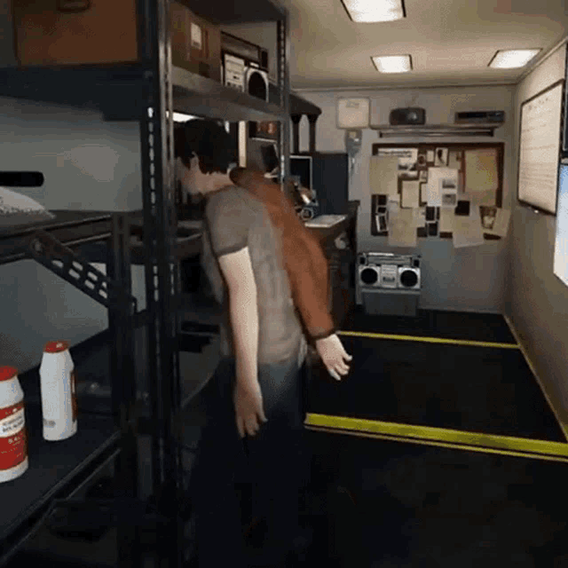 a man is standing in a room with shelves and a radio on the wall
