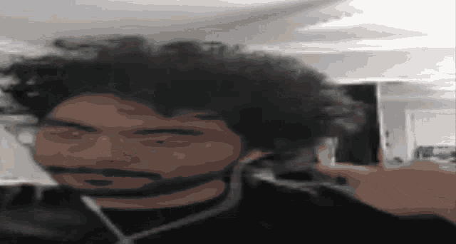 a pixelated image of a man with a beard and headphones