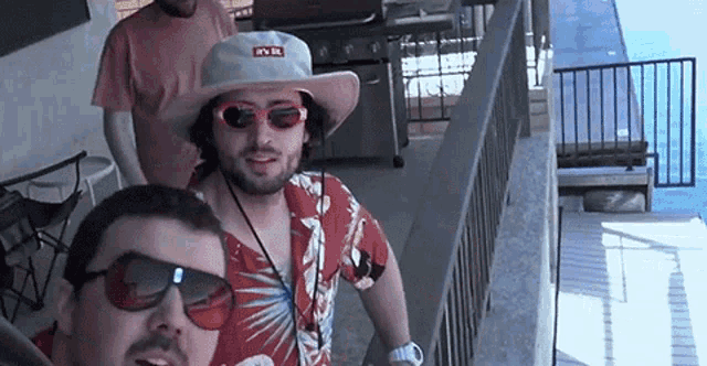 a man wearing sunglasses and a hat that says it 's lit on it
