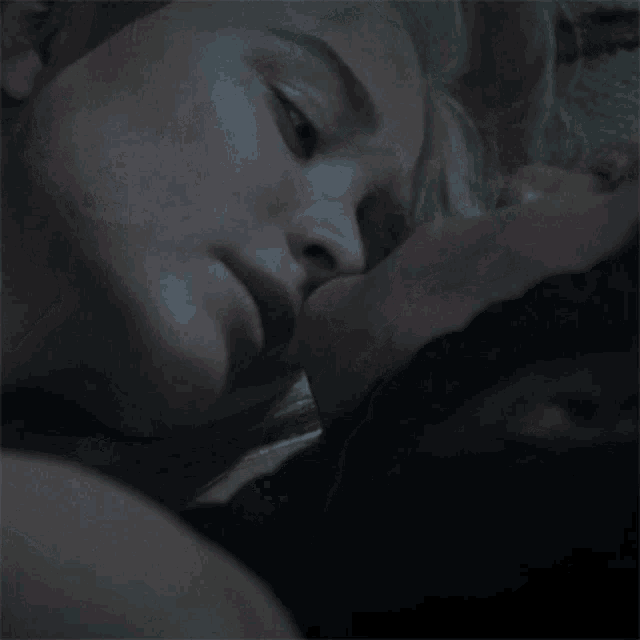 a man and a woman are kissing in the dark