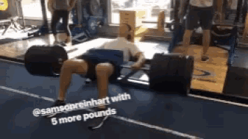 a man is lifting a barbell in a gym with a caption that says " 5 more pounds "