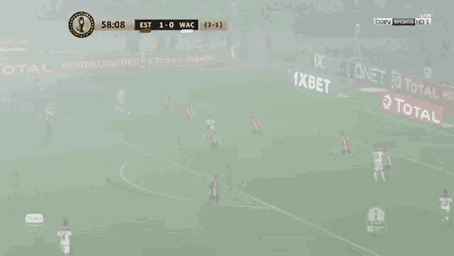 a soccer game is being played in a foggy stadium