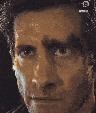 a close up of a man 's face with the word moist on the bottom right corner