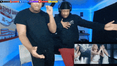 two men are dancing in front of a sign that says " x "
