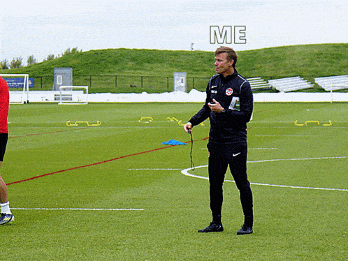 a man standing on a soccer field with the word me written above him